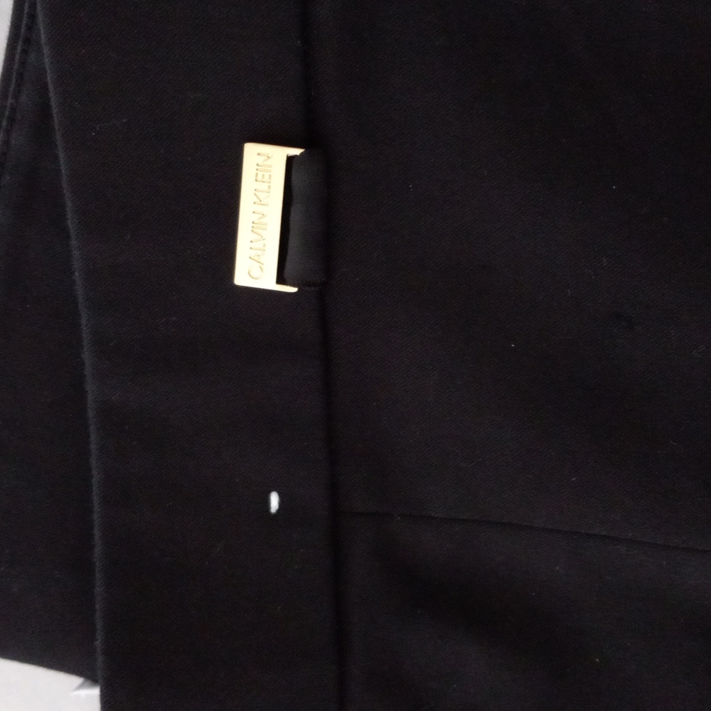 Black Calvin kline dress pants with slim ankle fit with a slit at open of pant